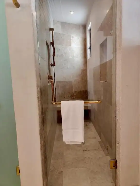 The way through to the shower, with a towel hanging.