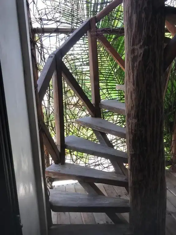 A wooden spiral staircase, seen from above.