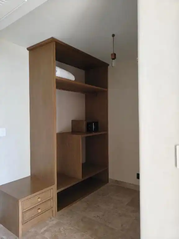 An open wooden closet, empty.