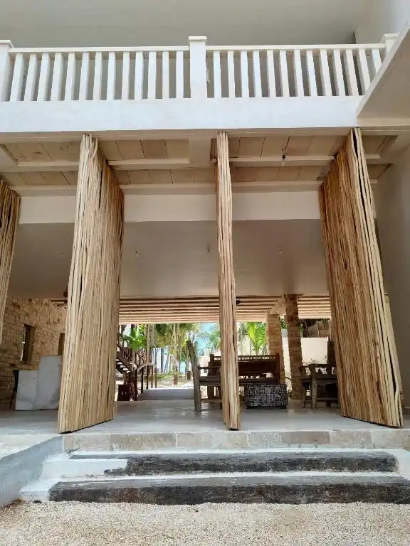 A facade with open wooden doors and stone steps.