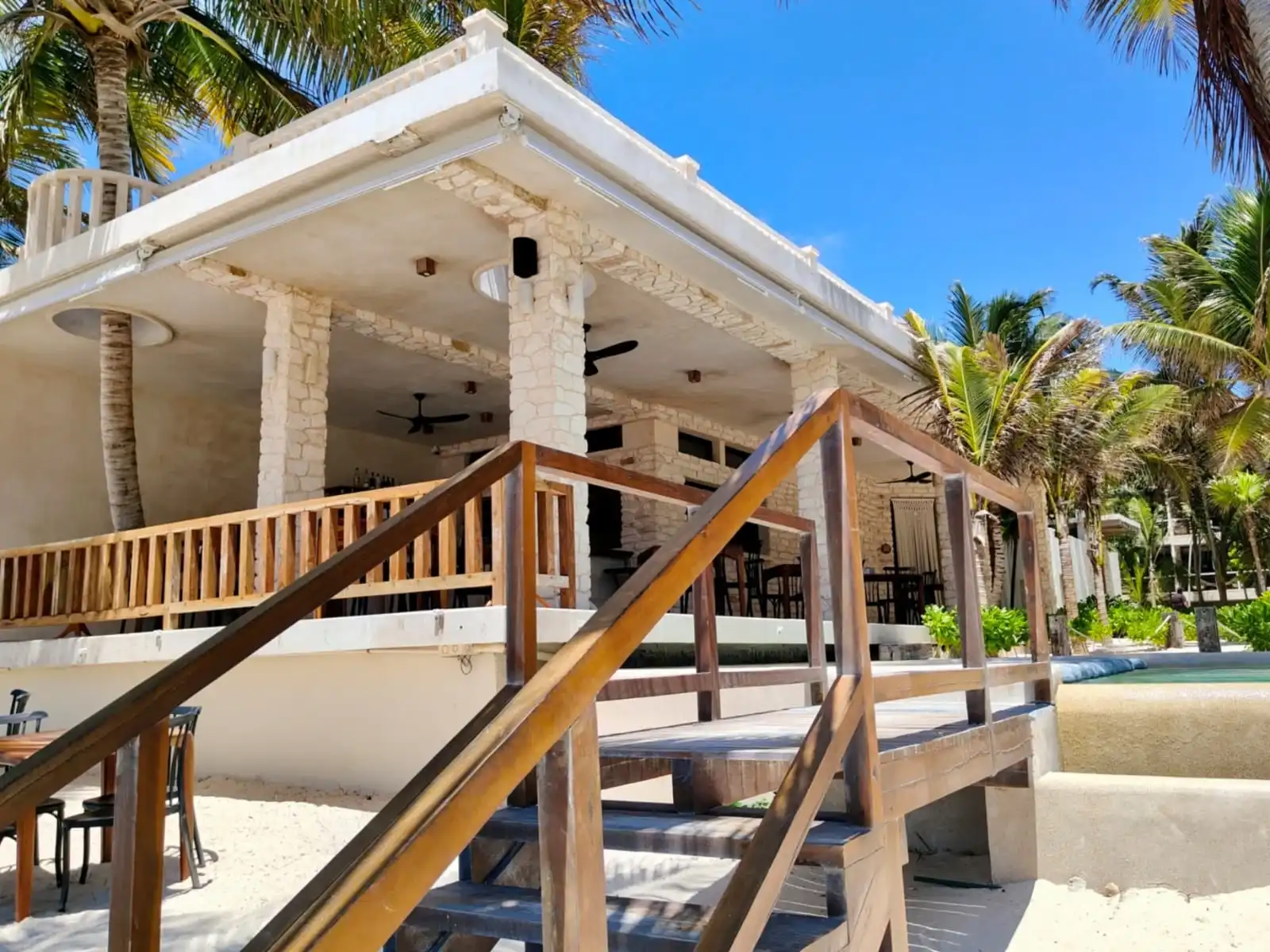 The beach restaurant, with its wooden staircase and the palapa over the stone columns.