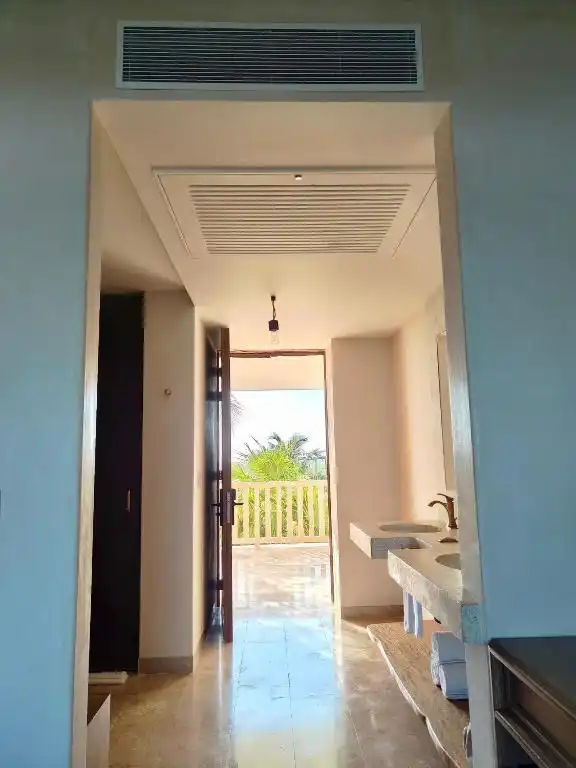 An interior passage to the washbasin, with the door open at the end.